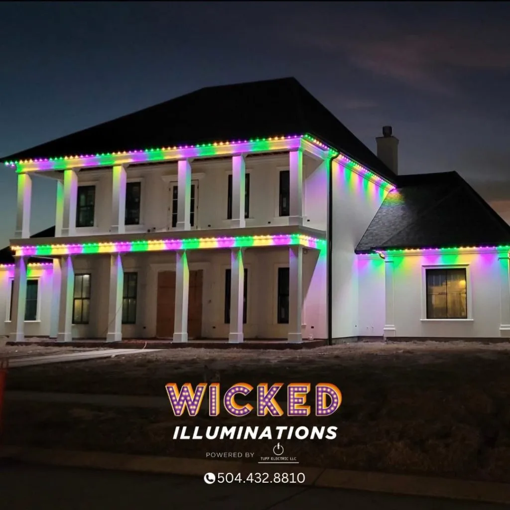 A house is adorned with colorful, festive lights outlining its structure